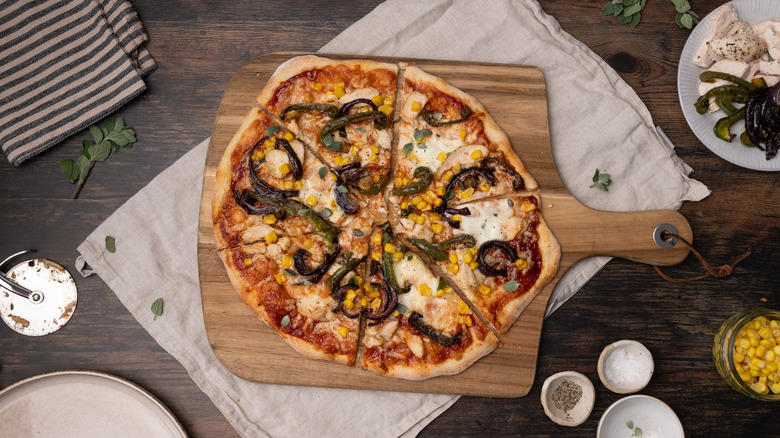 barbecue chicken pizza on cutting board