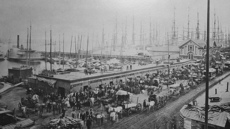 View of dock workers and ships beyond on the Lower Manhattan docks