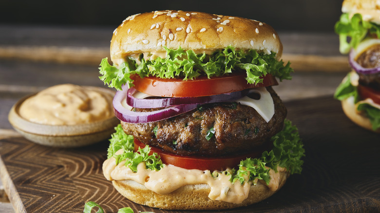Burger with onions, lettuce, tomato