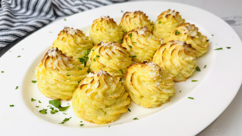 Garlic parmesan duchess potatoes on serving platter