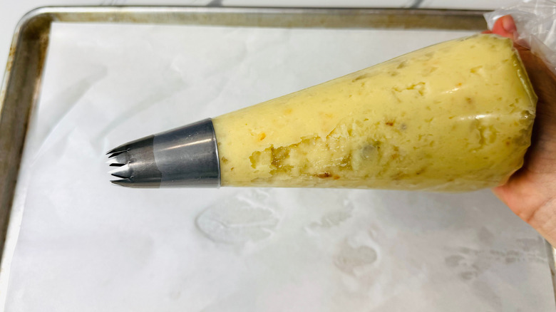 Piping bag full of mashed potato mixture