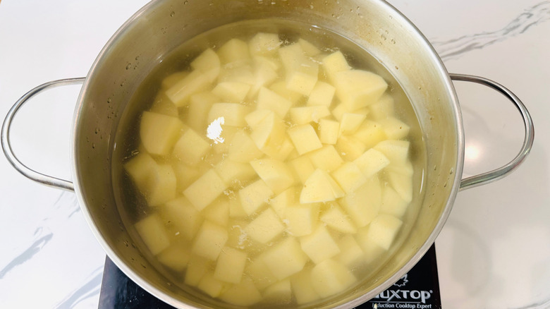 Cubed potatoes in pot of water