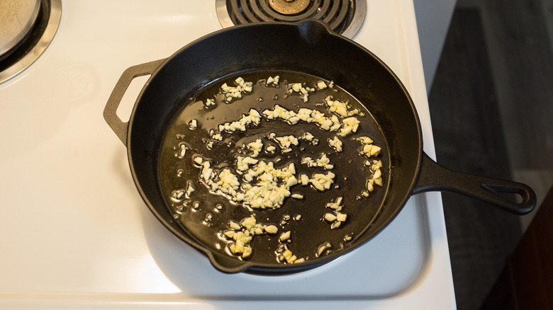 garlic sauteing in iron pan
