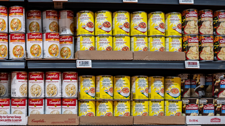 Grocery store shelf of soup showing Campbell's brand, Campbell's Chunky, and generic brand in different flavors