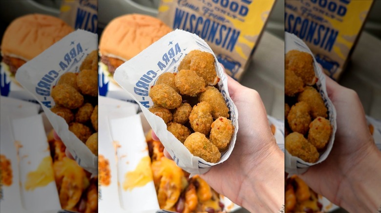 Hand holding bag of Culver's fried cheese curds
