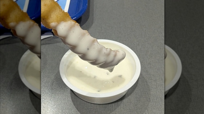 Culver's fry being dipped into ranch dressing