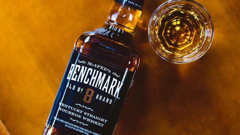 A bottle of McAfee's Benchmark Old Number 8 whiskey and glass.