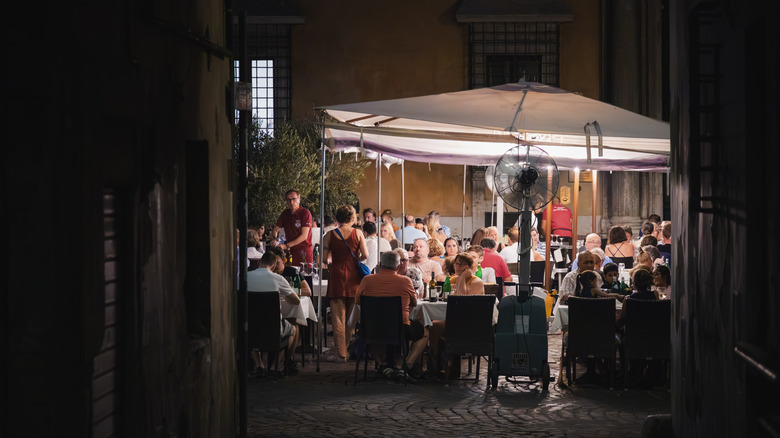 Diners eating in a restaurant in Rome at night