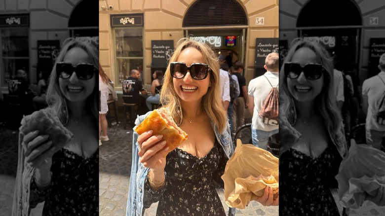 Giada De Laurentiis smiling and holding a pizza bianca