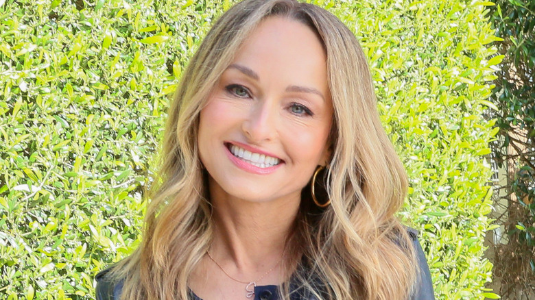 Giada De Laurentiis in front of a hedge