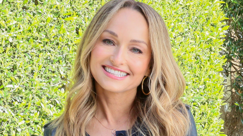 Giada De Laurentiis in front of a hedge