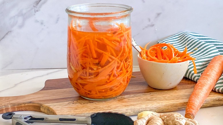 pickled carrots in glass jar and side bowl