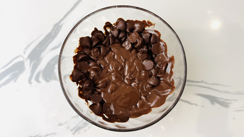 Partially melted chocolate and oil in a bowl
