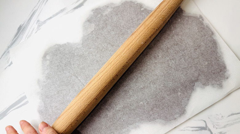 Rolled chocolate cookie dough between parchment paper