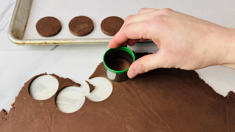 Cutting out chocolate cookie dough rounds