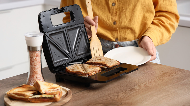 Person making paninis in home kitchen