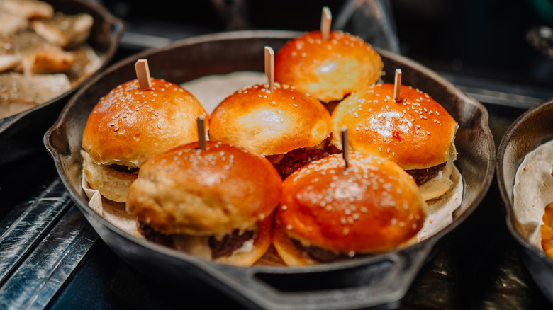 A skillet of golden, buttery sliders