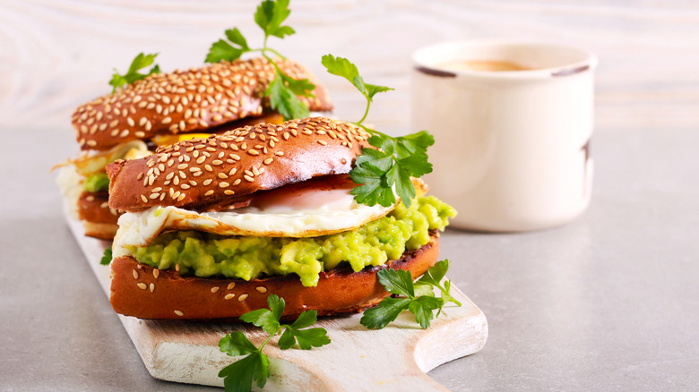 Sandwiches with mashed avocado, eggs, and cilantro.