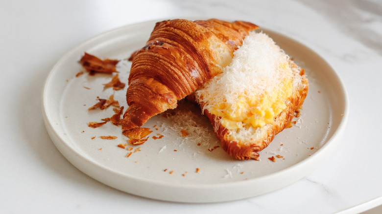 Croissant sandwich with eggs and grated parmesan.