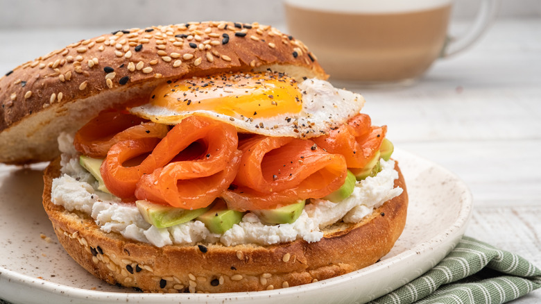 Lox bagel with eggs and avocado.