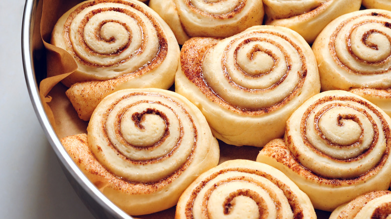 Close-up of raw cinnamon rolls in baking dish