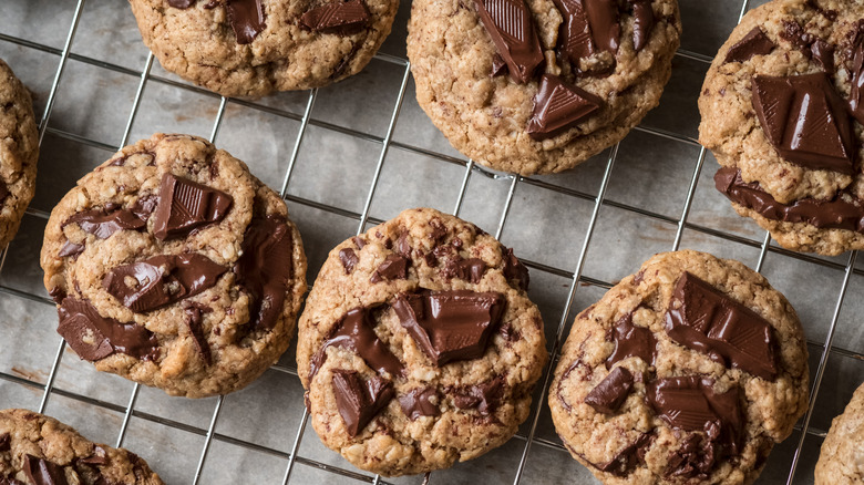 A wire rack of cooling chocolate chip cookies