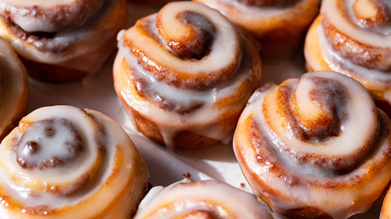 The sun shining on freshly glazed cinnamon rolls