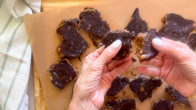 hands breaking up bark