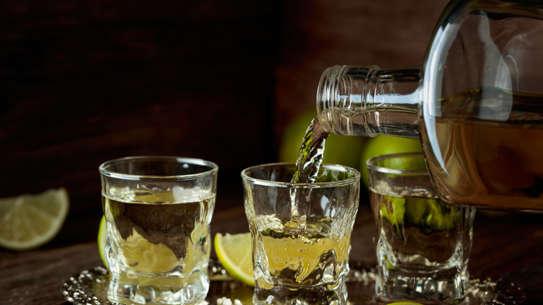 Pouring tequila into shot glasses