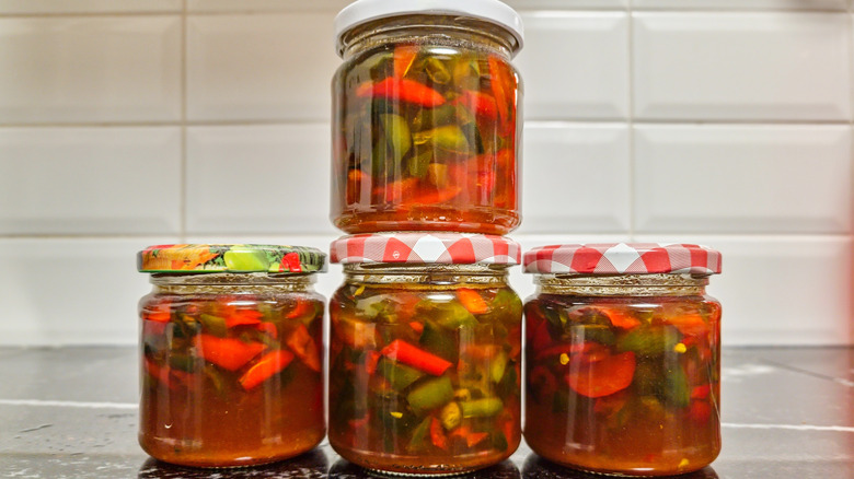 Pickled jalapeno peppers and apple cider vinegar in a jar