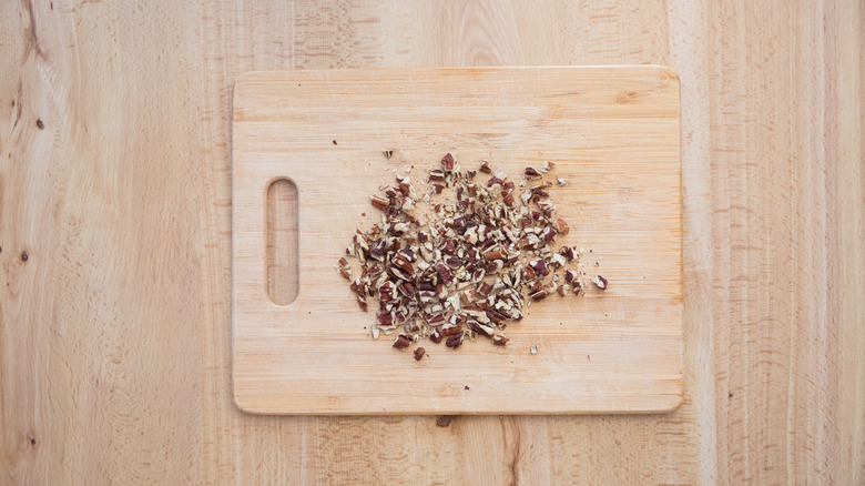chopped pecans on wooden board
