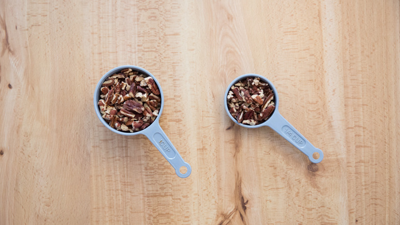 chopped pecans in measuring cups
