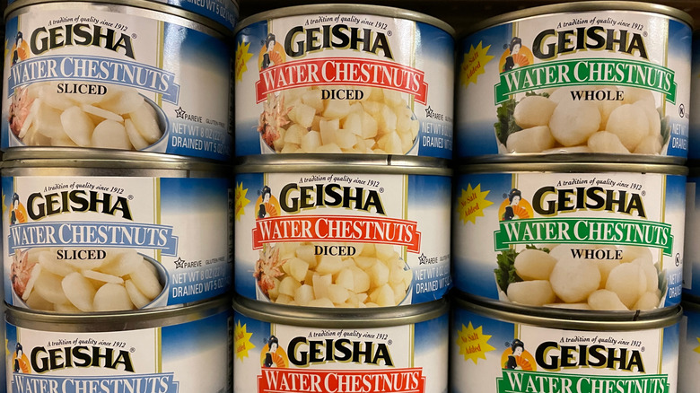 Nine stacked cans of Geisha water chestnuts, with three each of sliced, diced, and whole