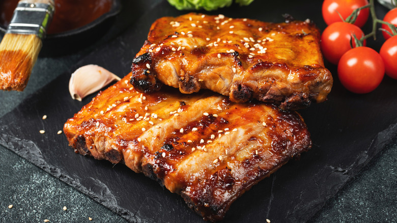 Marinated pork ribs with sesame seeds on a black countertop