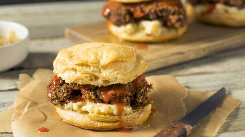 burger on a honey layered biscuit with knife