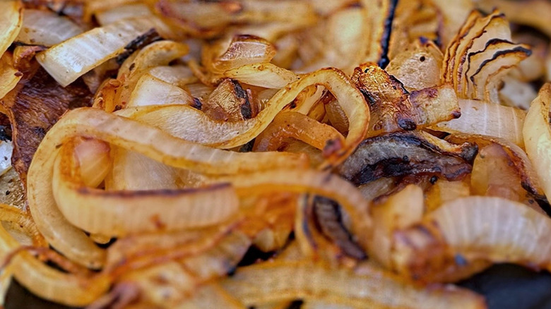 A pile of caramelized onions is pictured close up.