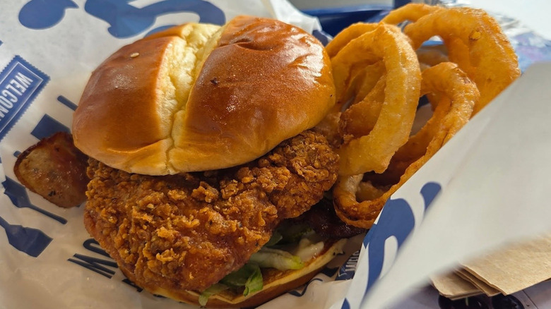 A Culver's chicken sandwich and onion rings are in a basket.