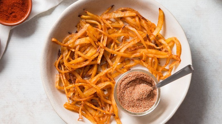 Fries and seasoning blend in bowl