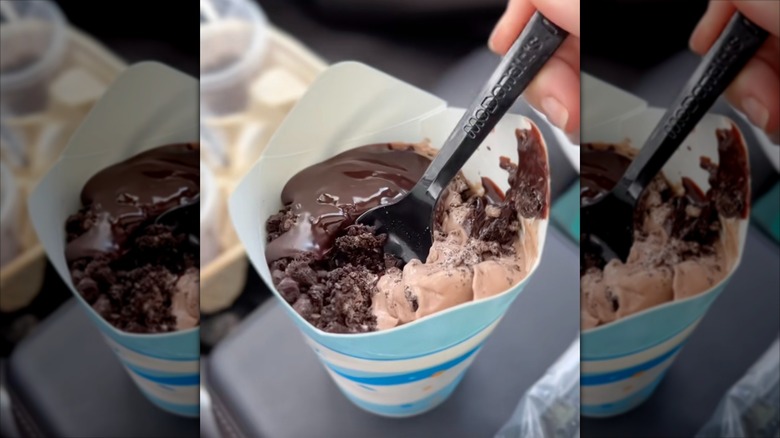 McDonald's chocolate McFlurry with extra hot fudge sauce and black plastic spoon