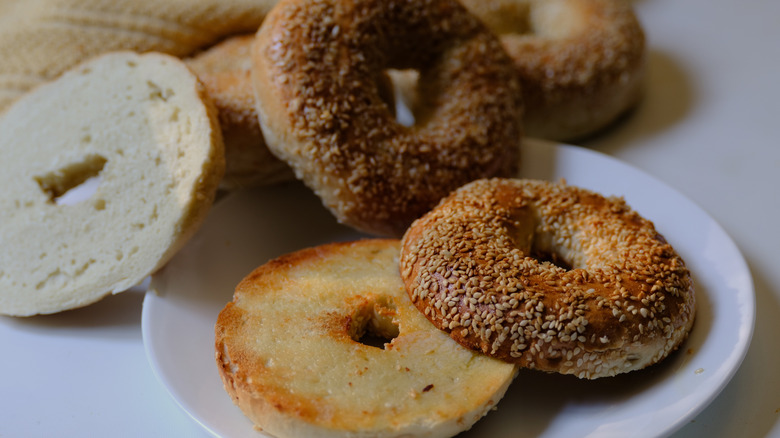 Scattered, assorted bagel halves on plate