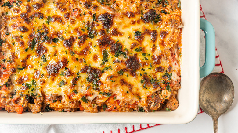 Cheeseburger casserole in a dish with a spoon