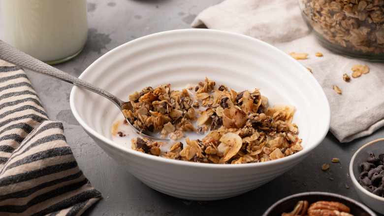 gluten-free coconut pecan granola in white bowl with spoon