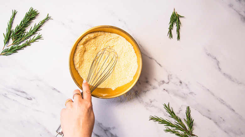 Mixing dry cake batter in bowl.