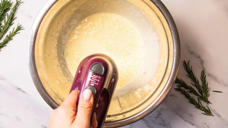 Whipping cake batter in bowl.