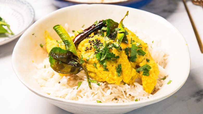White bowl with rice topped with Goan ghotache sasav curry