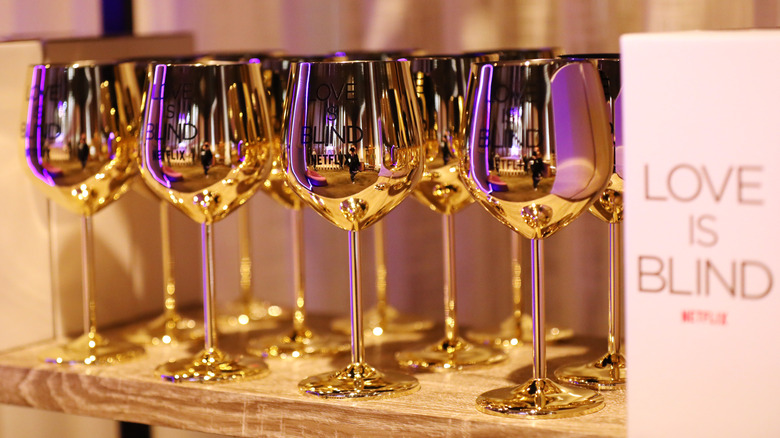 "Love Is Blind" branded gold metallic wine glasses
