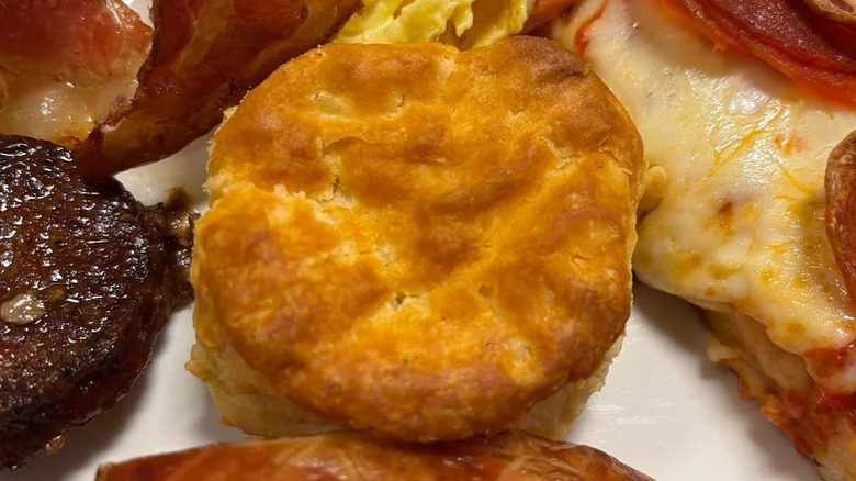 Biscuit on plate with other buffet items