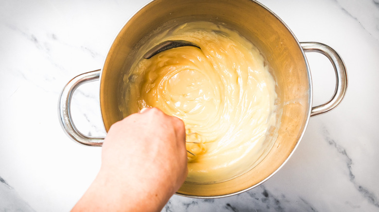 Stirring caramel in pot.