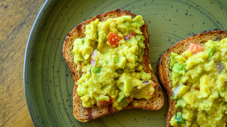 Avocado toast on a green plate