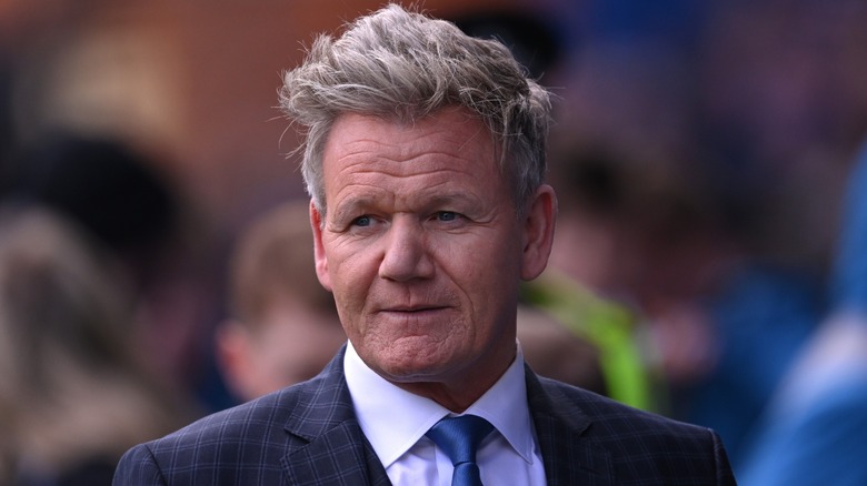 Gordon Ramsay wearing a suit with a blue tie